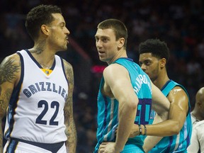 Charlotte Hornets forward Tyler Hansbrough (50) argues with Memphis Grizzlies forward Matt Barnes (22) during the first half at Time Warner Cable Arena. Jeremy Brevard-USA TODAY Sports