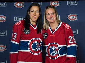 Caroline Ouellette, left, and Marie-Philip Poulin show of their team's new jersey Thursday, September 24, 2015, in Montreal. The CWHL Montreal-based franchise has also been renamed to become Les Canadiennes. THE CANADIAN PRESS/Paul Chiasson