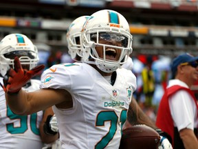 Miami Dolphins cornerback Brent Grimes (21) celebrates his interception during the first half of an NFL football game against the Washington Redskins, Sunday, Sept. 13, 2015, in Landover, Md. (AP Photo/Evan Vucci)