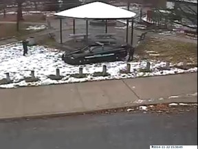 A police officer (L) is seen pointing his weapon during an incident involving the shooting of a 12-year-old boy with a pellet gun at the Cudell Recreation Center in Cleveland, Ohio, in this still image from video released by the Cleveland Police Department November 26, 2014.  Tamir E. Rice was shot by a patrol officer on Saturday after a 911 call reported someone pointing a gun at people at the Cudell Recreation Center.  REUTERS/Cleveland Police Department/Handout via Reuters