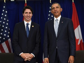 In this Nov. 19, 2015 file photo, President Barack Obama and Canadian Prime Minister Justin Trudeau stand up following their bilateral meeting at the Asia-Pacific Economic Cooperation summit in Manila, Philippines. The White House says Trudeau will attend a state dinner on March 10 in a visit intended to boost ties between the neighboring countries. (AP Photo/Susan Walsh, File)