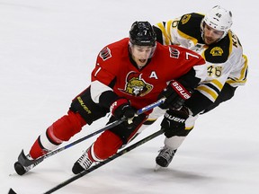 Ottawa Senators center Kyle Turris (7) is checked by Boston Bruins center David Krejci (46) during NHL action in Ottawa, Ont. on Sunday December 27, 2015. (Errol McGihon/Ottawa Sun/Postmedia Network)