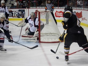 Windsor Spitfires goalie Garret Hughson keeps an eye on the puck as Sarnia Sting forward Noah Bushnell tries to make a move towards the net during the Ontario Hockey League game at the WFCU Centre (on Monday Dec. 28, 2015 in Windsor, Ont.). The Sting and Spitfires met for the second time this season. (Terry Bridge, The Observer)