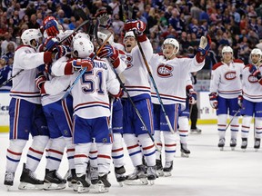 Members of the Canadiens mob Max Pacioretty after his goal against the Lightning during the shootout on Monday, Dec. 28, 2015, in Tampa, Fla. (Chris O'Meara/AP Photo)