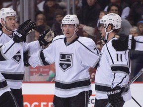 Kings centre Tyler Toffoli (73) celebrates his goal against the Canucks with teammates Drew Doughty (8), Brayden McNabb (3) and Anze Kopitar (11) during first period NHL action in Vancouver Monday, Dec. 28, 2015. (Jonathan Hayward/THE CANADIAN PRESS)
