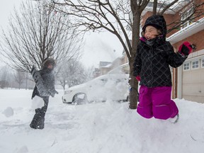 Five-year-old Tessa Snow plays while her mom Heidi Snow shovels after a big snow storm from 2015. Errol McGihon/Ottawa Sun/Postmedia Network