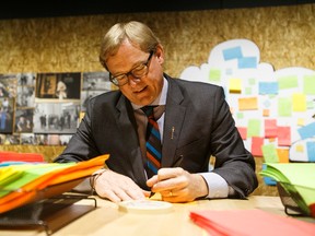 David Eggen, Alberta's Minister of Education and Minister of Culture and Tourism, fills out a museum memory for the memory board at the Royal Alberta Museum in Edmonton, Alta., on Friday December 4, 2015. Ian Kucerak/Postmedia Network