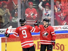 Canada's Mathew Barzal celebrates his game-winning shootout goal with teammate Dylan Strome against Switzerland in the preliminary round at the IIHF World Junior Championship in Helsinki on Dec. 29, 2015. (THE CANADIAN PRESS/Sean Kilpatrick)