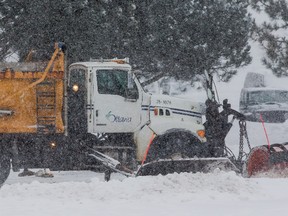 A City of Ottawa snowplow works to clear the first major snowfall of the year on Tuesday December 29, 2015. Errol McGihon/Ottawa Sun/Postmedia Network