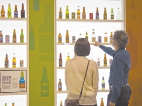 Visitors admire a wall of bottles inside the Waterloo Region Museum beer hall.
