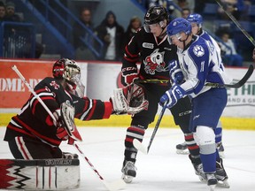 Niagara Ice Dogs goalie Stephen Dhillon makes a save as Sudbury Wolves Alan Lyszczarczyk looks for the rebound during OHL action in Sudbury, Ont. on Tuesday December 29, 2015.