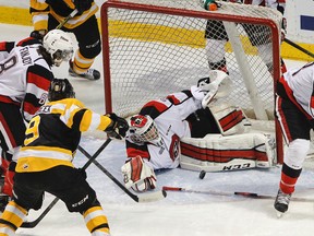 Kingston Frontenacs’ Zack Dorval, right, waits to put the loose puck past Ottawa 67’s goaltender Leo Lazarev from a goalmouth scramble during first-period Ontario Hockey League action at the Rogers K-Rock Centre on Tuesday night. Ottawa won 5-2. (Julia McKay/The Whig-Standard)