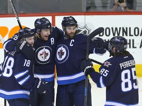 Winnipeg Jets left winger Andrew Ladd (second from right) celebrates his goal against the Detroit Red Wings with (left to right) Bryan Little, Blake Wheeler  and Mathieu Perreault during NHL hockey in Winnipeg, Man. Tuesday December 29, 2015.
Brian Donogh/Winnipeg Sun/Postmedia Network