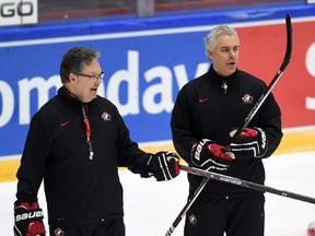 Team Canada assistant coaches Dominique Ducharme, right, and Kelly McCrimmon talk during practice at the World Junior Championship in Helsinki, Finland, on Wednesday, December 30, 2015. (THE CANADIAN PRESS/Sean Kilpatrick)