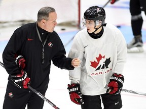 Canada head coach Dave Lowry (left) talks with forward Mitch Marner during practice at the World Junior Championship in Helsinki, Finland, on Wednesday, December 30, 2015. (THE CANADIAN PRESS/Sean Kilpatrick)