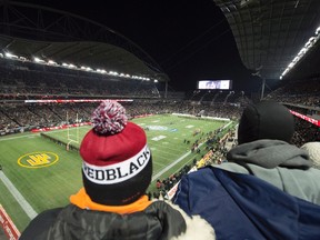 Football fans sing during the national anthem during the 103rd Grey Cup at Investors Group Field last month. (THE CANADIAN PRESS/Jonathan Hayward file photo)