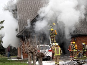 Firefighters from Dover and Tupperville stations were called to battle a fire that began in the attached garage of W. Lewis Line home near Mitchell's Bay, Ont. on Wednesday December 30, 2015. Ellwood Shreve/Chatham Daily News/Postmedia Network