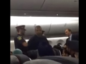 Peel Regional Police are seen arresting a man who allegedly assaulted a flight attendant on an Air Canada flight in this still from a video posted to YouTube.