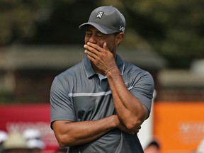 In this Aug. 21, 2015, file photo, Tiger Woods reacts after missing a putt on the ninth hole during the second round of the Wyndham Championship in Greensboro, N.C. (AP Photo/Chuck Burton)
