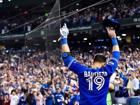 Toronto Blue Jays right fielder Jose Bautista acknowledges the crowd after hitting a three-run home run against the Texas Rangers during Game 5 of the American League Division Series in Toronto on Oct. 14, 2015. (THE CANADIAN PRESS/Nathan Denette)