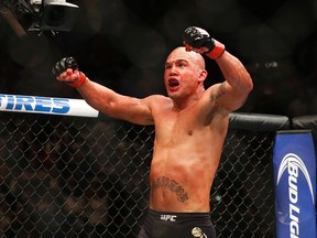 Robbie Lawler celebrates after defeating Rory MacDonald in their welterweight title bout at UFC 189 in Las Vegas on July 11, 2015. (AP Photo/John Locher)