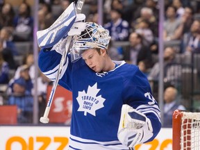 Toronto Maple Leafs goalie James Reimer puts on his helmet during a game against the New York Islanders at the Air Canada Centre in Toronto on Dec. 29, 2015. (THE CANADIAN PRESS/Chris Young)