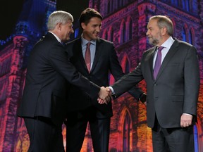 Liberal Party leader Justin Trudeau (middle) joins NDP leader Thomas Mulcair (right) and Conservative Party leader Stephen Harper (left) at the first leaders' debate on Thursday September 17, 2015. Stuart Dryden/Calgary Sun/Postmedia Network