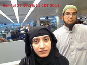 This July 27, 2014 file photo provided by U.S. Customs and Border Protection shows Tashfeen Malik, left, and her husband, Syed Farook, as they passed through O'Hare International Airport in Chicago. (U.S. Customs and Border Protection via AP, File)