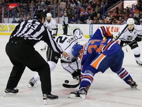 Dec 29, 2015; Edmonton, Alberta, CAN; Los Angeles Kings forward Trevor Lewis (22) and Edmonton Oilers forward Matt Hendricks (23) face-off during the first period at Rexall Place. Mandatory Credit: Perry Nelson-USA TODAY Sports
