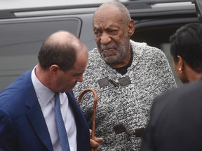 Actor and comedian Bill Cosby, centre, arrives for his arraignment on sexual assault charges at the Montgomery County Courthouse in Elkins Park, Pennsylvania December 30, 2015.  Cosby was charged on Wednesday with sexually assaulting a woman in 2004 after plying her with drugs and alcohol, marking the first criminal case against a once-beloved performer whose father-figure persona was already left tattered by dozens of misconduct allegations. (REUTERS/Mark Makela)