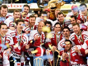Team Canada poses with the trophy after winning the final match against Switzerland's HC Lugano, at the 89th Spengler Cup hockey tournament in Davos, Switzerland, Thursday, Dec. 31, 2015. (Gian Ehrenzeller/Keystone via AP)