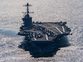 In this Friday, Dec. 25, 2015 photo released by the U.S. Navy, the aircraft carrier USS Harry S. Truman navigates the Gulf of Oman. Iranian naval vessels conducted rocket tests last week near the USS Harry S. Truman aircraft carrier, the USS Bulkeley destroyer and a French frigate, the FS Provence, and commercial traffic passing through the Strait of Hormuz, the American military said Wednesday, Dec. 30, 2015 causing new tension between the two nations after a landmark nuclear deal. (Mass Communication Specialist 3rd Class J. M. Tolbert/ U.S. Navy via AP)
