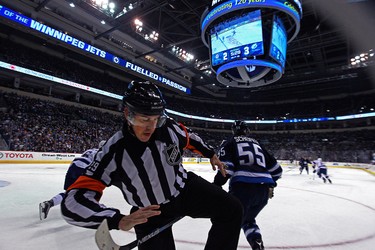2015 YEAR IN REVIEW � Winnipeg Jets centre Mark Scheifele gets his stick caught between the legs of referee Ian Walsh during NHL action against the Tampa Bay Lightning at MTS Centre in Winnipeg on Fri., Oct. 23, 2015. Kevin King/Winnipeg Sun/Postmedia Network