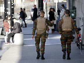Belgian soldiers patrol in central Brussels on December 31, 2015. Belgian police are probing a reported orgy between that happened in November involving two policewomen and soldiers. REUTERS/Francois Lenoir