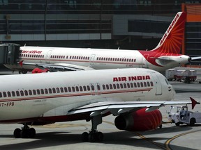 In this May 18, 2012 file photo, Air India planes are parked on the tarmac at the Terminal 3 of Indira Gandhi International Airport in New Delhi, India.  An Air India plane flying to London was forced to return to Mumbai after passengers spotted a rat on board, the airline said Thursday, Dec. 31, 2015. (AP Photo/Kevin Frayer, File)