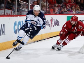 Blake Wheeler skates with the puck ahead of Keith Yandle of the Arizona Coyotes during a game last season. (Christian Petersen/Getty Images/AFP file photo)