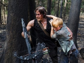 This photo provided by AMC shows, Norman Reedus, left, as Daryl Dixon and Liz E. Morgan as Tina, in a scene from season 6 of the television series, "The Walking Dead." (Gene Page/AMC via AP)