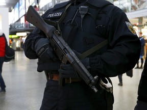 A German police officer secures the main train station in Munich, Germany, on Jan. 1, 2016. (REUTERS/Michaela Rehle)