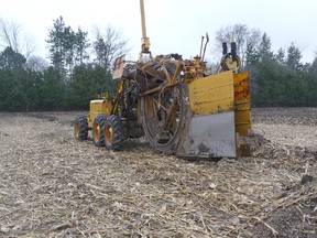 A tiling machine ready to work on a field on Waterworks Roads in East Sarnia. The slow moving machine slices a thin wedge into the ground. A laser eye is used to ensure accurate slope. Soil conditions must be just right for a tiling machine to work properly because if it is too dry, the machine can’t go through the soil.  Most tiling is installed in fall, after the crops have been harvested, or mid-summer after the winter wheat has been taken off. Farmers who tile their fields are looking to boost their yields, as crops grow better in well-drained fields. HANDOUT/ SARNIA OBSERVER/ POSTMEDIA NETWORK