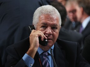 Florida Panthers GM Dale Tallon speaks on the phone on Day Two of the NHL draft at the Wells Fargo Center in Philadelphia on June 28, 2014. (Bruce Bennett/Getty Images/AFP)