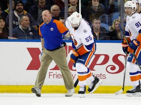 New York Islanders defenseman Johnny Boychuk (55) goes off the ice with a trainer during the third period against the Buffalo Sabres at First Niagara Center in Buffalo on Dec. 31, 2015. (Timothy T. Ludwig/USA TODAY Sports)