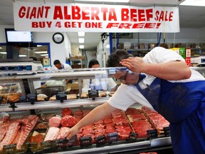 A butcher organizes choice cuts of Alberta beef at Bon Ton Meat Market in Calgary, Alberta in this file photo taken October 3, 2012. (REUTERS/Todd Korol/Files)