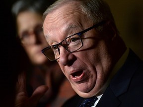Senator Jacques Demers speaks to media in the foyer of the Senate on Parliament Hill in Ottawa on Dec. 3, 2015. (THE CANADIAN PRESS/Sean Kilpatrick)