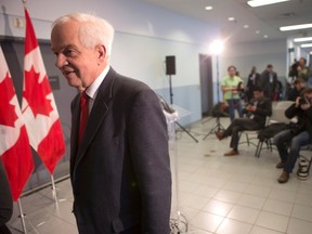 Immigration Minister John McCallum leaves after briefing journalists at the Welcome Centre in Toronto's Pearson Airport on Thursday, December 31, 2015. THE CANADIAN PRESS/Chris Young