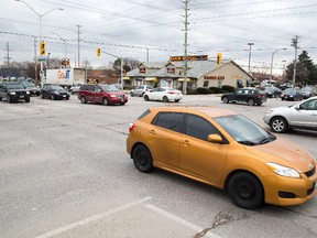 The busyness of London intersections such as Fanshawe Park Road and Richmond Street has spawned a debate about the usefulness of red light cameras. (Free Press file photo)