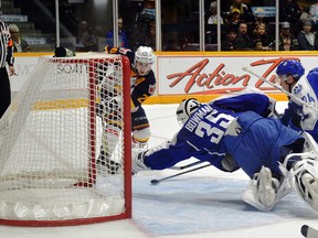 The Barrie Colts' Andrew Mangiapane (26) slaps in a third period goal past a sprawiling Wolves' goalie Zack Bowman as Barrie doubled up on Sudbury 6 -3 to take the annual New Year's Eve game at the Barrie Molson Centre.