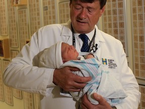 Dr. Nicholas Pairaudeau holds Julian, Toronto's first baby of 2016, born 39 seconds past midnight on Jan. 1.