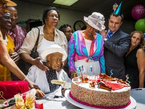 Susannah Mushatt Jones (C), known as "Miss Susie" celebrates her 116th birthday with family members, local dignitaries, and friends in the Brooklyn borough of New York, July 7, 2015. Jones, who has become the world's oldest living person, is the daughter of sharecroppers and granddaughter of slaves. Her 116th birthday was officially on Monday but celebrated today in New York. REUTERS/Lucas Jackson
