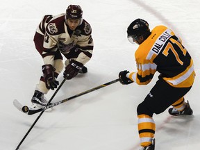 Kingston Frontenacs' Michael Dal Colle battles for the puck with Peterborough Petes' Jonathan Ang during the second period of Ontario Hockey League action at the Rogers K-Rock Centre in Kingston on Friday. (JULIA MCKAY/The Whig-Standard)