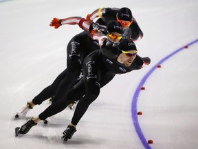 Canada's Ted-Jan Bloemen, right, leads teammates Jordan Belchos, centre, and Benjamin Donnelly to victory during the men's team pursuit competition at the ISU World Cup speed skating event in Calgary, on Saturday, Nov. 14, 2015. (THE CANADIAN PRESS/Jeff McIntosh)